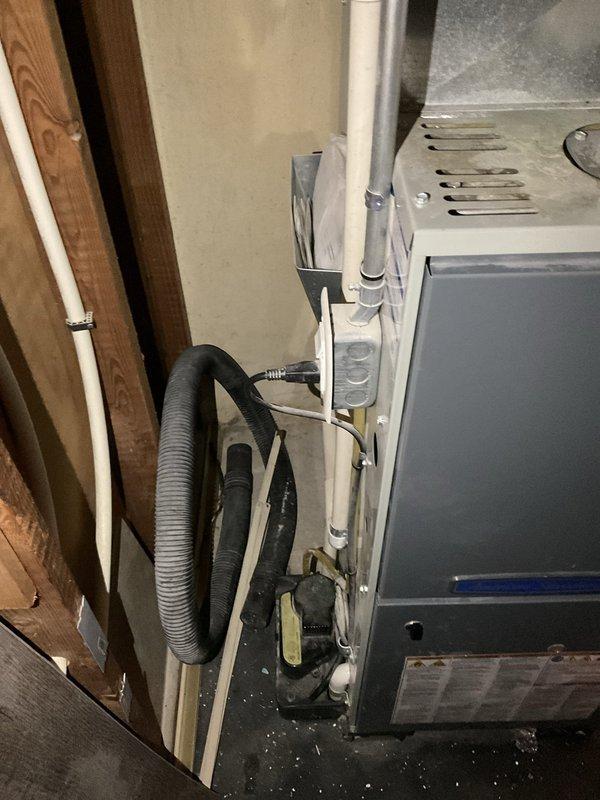 Conducted on-site assessment of existing HVAC system for air conditioning replacement estimate. Evaluated current furnace installation with Aprilaire humidification system, inspected ductwork condition and routing, and documented mechanical room configuration including PVC condensate drainage, copper refrigerant lines, and existing control systems. Photographed equipment layout and spatial constraints to develop accurate replacement proposal for new air conditioning unit compatible with current infrastructure.
