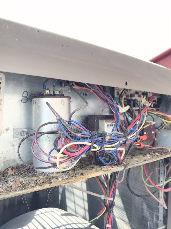 Completed routine HVAC maintenance agreement visit for air conditioning and system inspection. Upon accessing the equipment compartment, documented significant dust and debris accumulation throughout the electrical control panel and internal components, including the capacitor, wiring bundles, and compressor housing area. Performed visual inspection of all accessible mechanical and electrical components, noting disorganized wiring conditions and general buildup that has accumulated during normal operation.