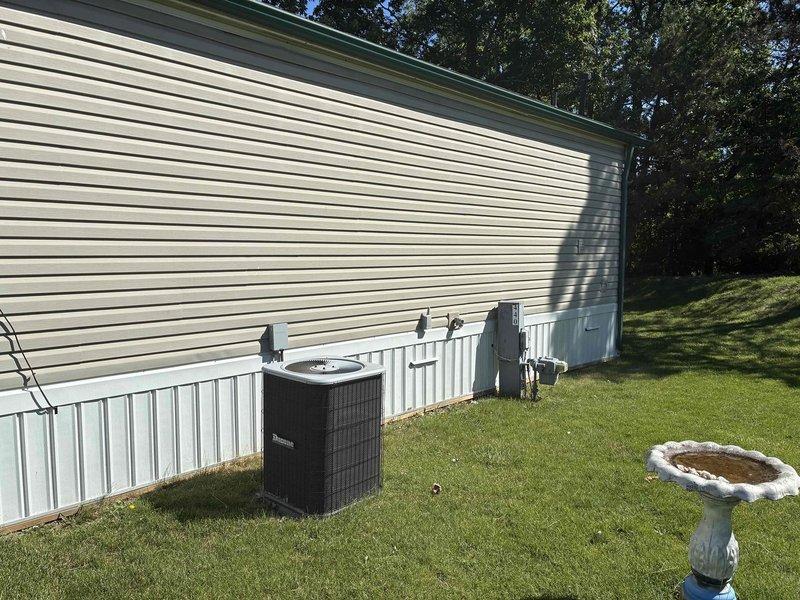 Conducted on-site evaluation for complete furnace replacement at residential mobile home property. Assessed existing HVAC system including outdoor air conditioning unit and electrical connections, documented current equipment configuration and installation requirements. Customer referred by family member, provided detailed estimate for furnace replacement with applicable referral discount applied to quoted price.