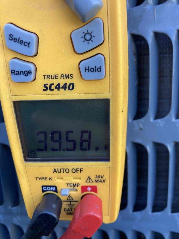 Completed Club AC10-2 preventive maintenance agreement visit on residential air conditioning system. Performed comprehensive inspection of outdoor condenser unit, including electrical diagnostics with multimeter showing 39.58 reading at heat exchanger coil, verified proper voltage levels, and confirmed system operational parameters within manufacturer specifications.