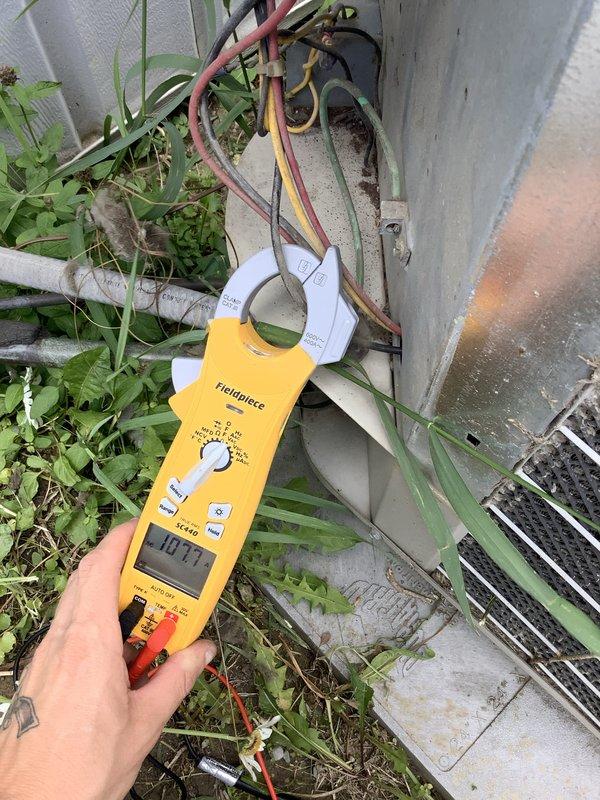Responded to no airflow complaint affecting one bedroom in mobile home while rest of house maintained normal heating and cooling operation. Conducted system diagnostics including electrical testing of outdoor unit showing 14.7V reading and visual inspection of indoor refrigerant lines and heat exchanger assembly. Determined airflow restriction was localized to single zone with all visible supply vents in open position. Advised that bedroom furniture placement, specifically bed positioning, was likely obstructing return air pathway or blocking supply register, preventing proper air circulation to affected room. Recommended relocating bed away from vents to restore adequate airflow distribution throughout ductwork system.