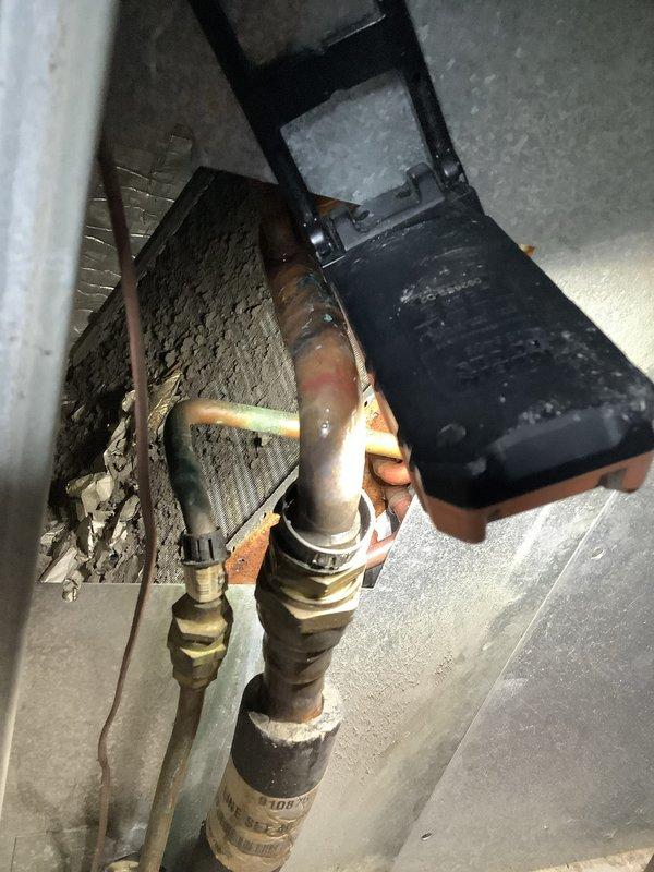 Responded to no airflow complaint affecting one bedroom in mobile home while rest of house maintained normal heating and cooling operation. Conducted system diagnostics including electrical testing of outdoor unit showing 14.7V reading and visual inspection of indoor refrigerant lines and heat exchanger assembly. Determined airflow restriction was localized to single zone with all visible supply vents in open position. Advised that bedroom furniture placement, specifically bed positioning, was likely obstructing return air pathway or blocking supply register, preventing proper air circulation to affected room. Recommended relocating bed away from vents to restore adequate airflow distribution throughout ductwork system.