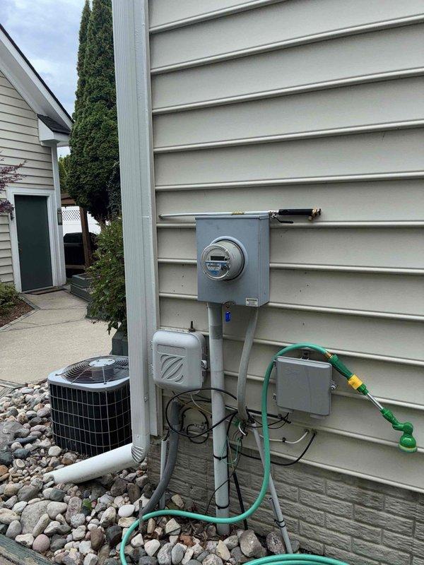 Responded to service call for air conditioning unit producing abnormal noise during operation. Upon inspection of the exterior condensing unit and evaluation of system performance, provided comprehensive estimate for complete HVAC system replacement. Assessment included evaluation of existing outdoor condenser unit positioned on rock bed foundation with proper electrical service connections, as well as interior thermostat displaying current temperature reading of 82°F. Documented existing equipment configuration and installation location for replacement specifications.