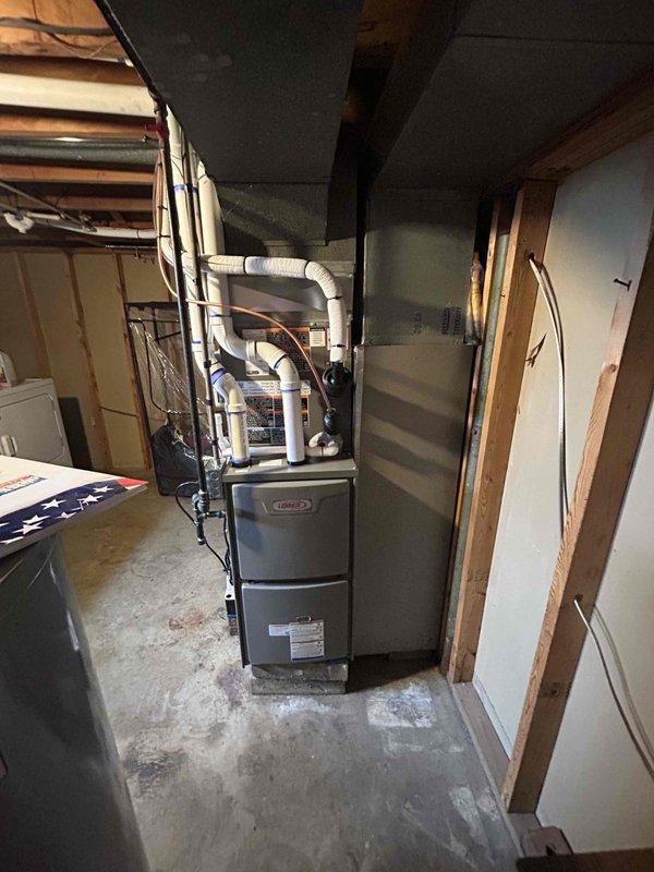 Completed full HVAC system installation including a 70,000 BTU furnace and 2-ton air conditioning unit at rear of property. Performed all mechanical and electrical connections, installed white PVC condensate drainage system with proper pitch and secured routing along foundation, mounted outdoor condenser unit with utility disconnect box, and ran refrigerant lines with appropriate insulation. Installed furnace in basement mechanical room with flexible supply ductwork connections to existing distribution system, verified all electrical connections meet code requirements, tested system operation and confirmed proper airflow and cooling capacity.