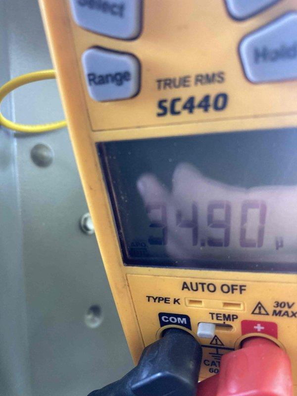 Completed preventive maintenance agreement visit for Club AC8-12 service on air conditioning and system inspection. Performed comprehensive electrical diagnostics using calibrated digital multimeter, recording voltage readings at 49.0V to verify proper system operation and electrical integrity. Inspected and documented all electrical connections, wiring bundles, and control components within the equipment enclosure, confirming all connections were secure with proper cable management and labeling in place. All system components including capacitors, terminal blocks, and wiring harnesses were found in good operating condition with no visible signs of wear, corrosion, or damage requiring immediate attention.
