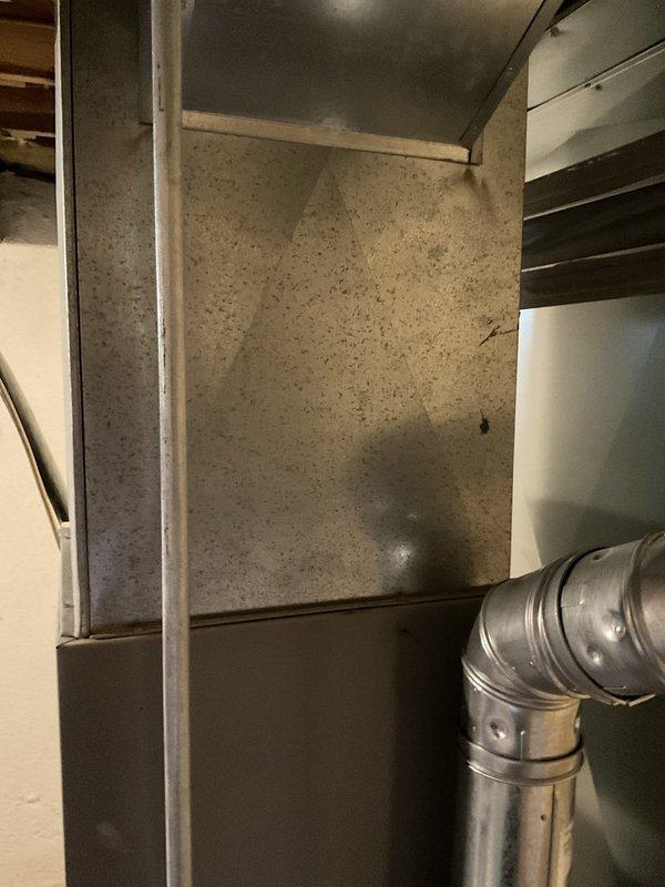Performed assessment of existing R-22 air conditioning system found to be low on refrigerant and requiring capacitor replacement. Due to age of equipment and cost considerations, provided comprehensive estimate for complete AC system replacement rather than repair of obsolete unit. Documented existing HVAC equipment configuration including Rheem furnace installation and current mechanical room layout.