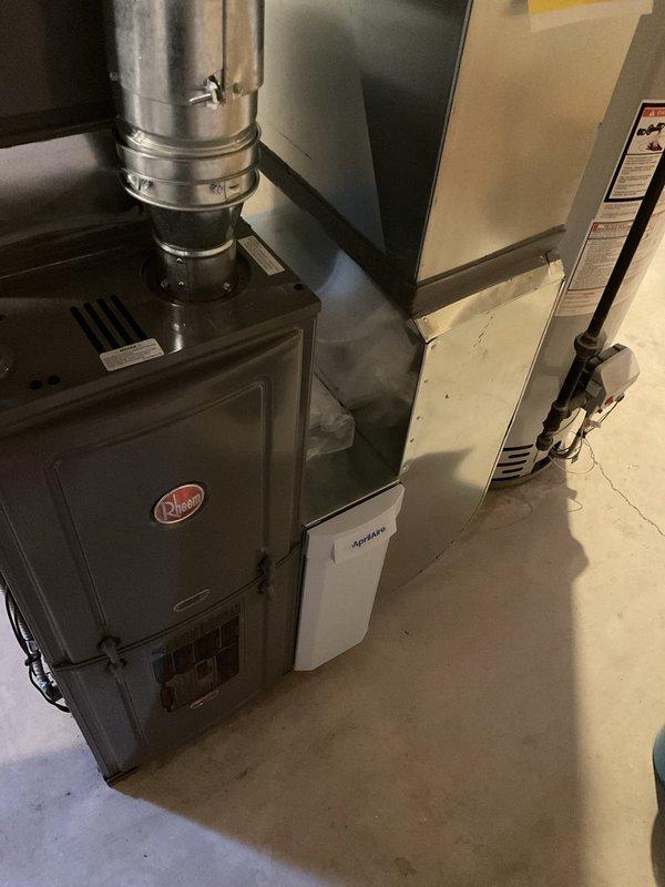 Performed assessment of existing R-22 air conditioning system found to be low on refrigerant and requiring capacitor replacement. Due to age of equipment and cost considerations, provided comprehensive estimate for complete AC system replacement rather than repair of obsolete unit. Documented existing HVAC equipment configuration including Rheem furnace installation and current mechanical room layout.