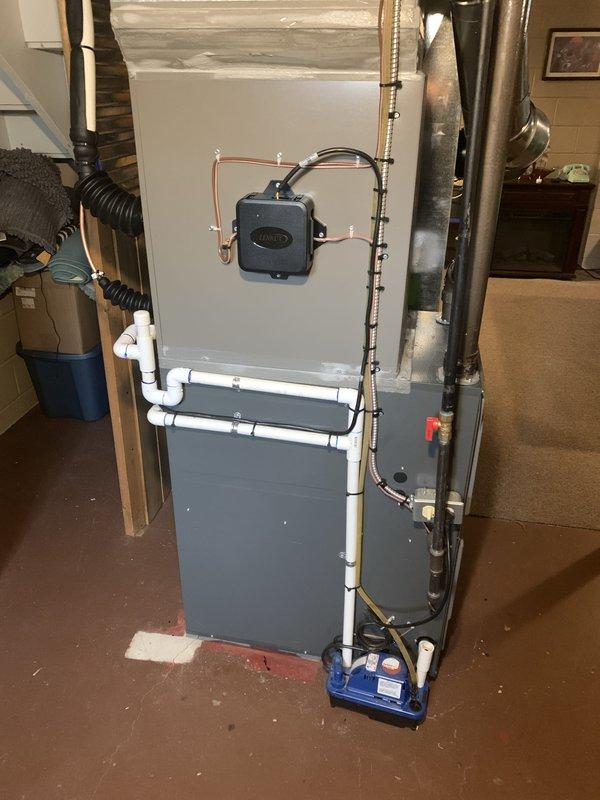 Completed installation of 3-ton air conditioning system with matching evaporator coil in rear yard location. Connected new outdoor condensing unit to existing furnace system in basement, installed new copper refrigerant lines, and integrated humidifier and condensate pump into updated HVAC configuration. All electrical connections, ductwork transitions, and PVC drainage lines were properly secured and tested for optimal system performance.