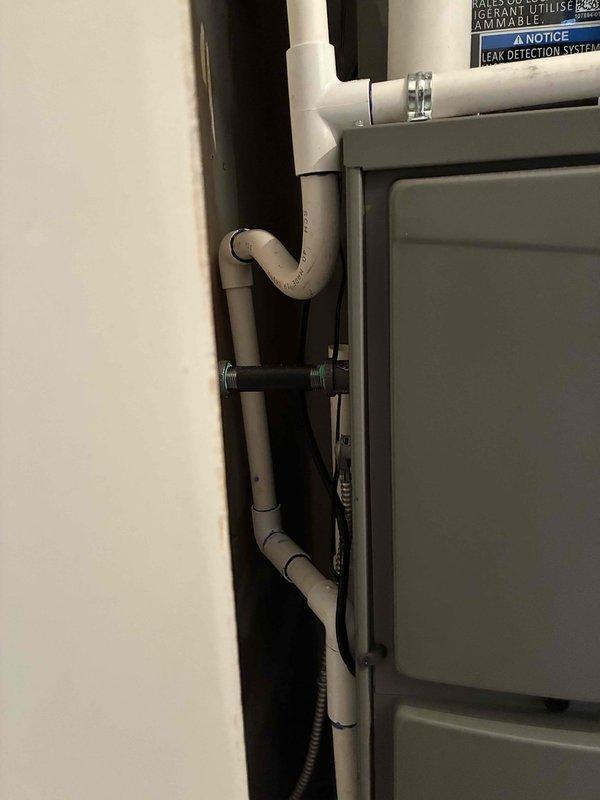 Completed full HVAC system installation including mechanical and electrical work. Installed 110,000 BTU furnace and 4-ton air conditioning unit in rear utility location. Configured condensate drainage system with PVC piping and connected leak detection system. Ran black flexible conduit for electrical connections and installed red-handled shut-off valve on supply lines. Reconnected all plumbing components including copper fittings and verified proper airflow and ventilation. System tested and operational upon completion.