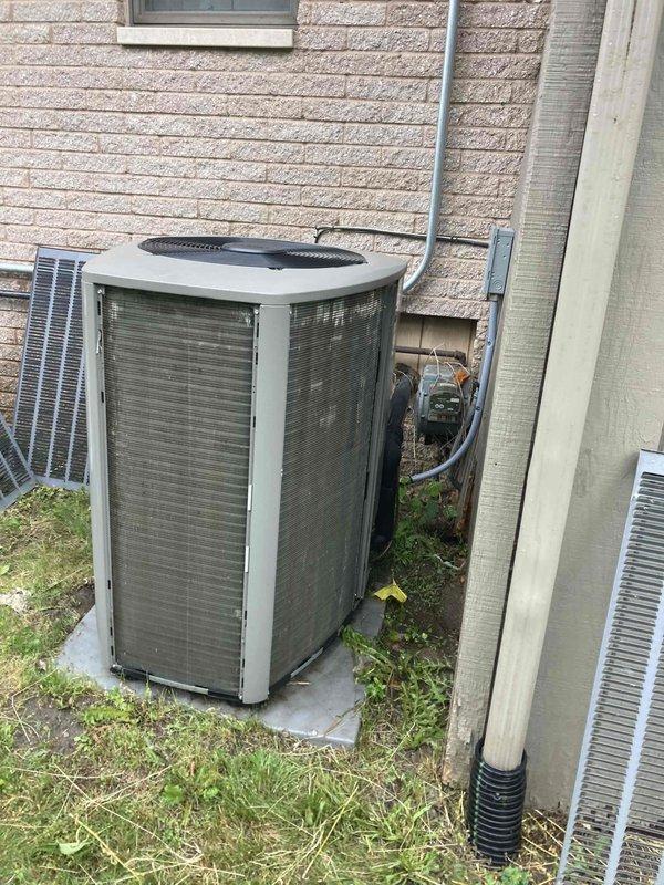 Completed comprehensive AC/furnace tune-up on residential HVAC system. Performed standard maintenance inspection of outdoor condensing unit, verified proper operation of all components, and documented equipment condition with photographs showing unit positioned on concrete pad against building exterior with refrigerant lines properly secured.