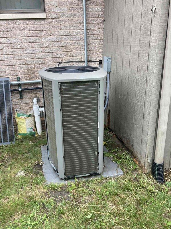 Completed comprehensive AC/furnace tune-up on residential HVAC system. Performed standard maintenance inspection of outdoor condensing unit, verified proper operation of all components, and documented equipment condition with photographs showing unit positioned on concrete pad against building exterior with refrigerant lines properly secured.