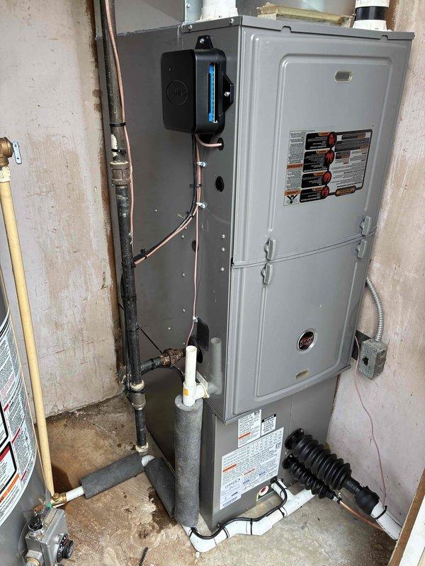 Completed installation of 2-ton air conditioning system with evaporator coil at rear location. Installed new outdoor condensing unit and indoor evaporator coil, completed all mechanical and electrical connections per manufacturer specifications. Performed vacuum test using digital micron gauge to verify system reached proper 22 micron level, ensuring complete moisture removal from refrigerant lines. Reconnected all components, charged system with refrigerant, and verified proper operation of complete HVAC system including furnace integration with new cooling equipment.