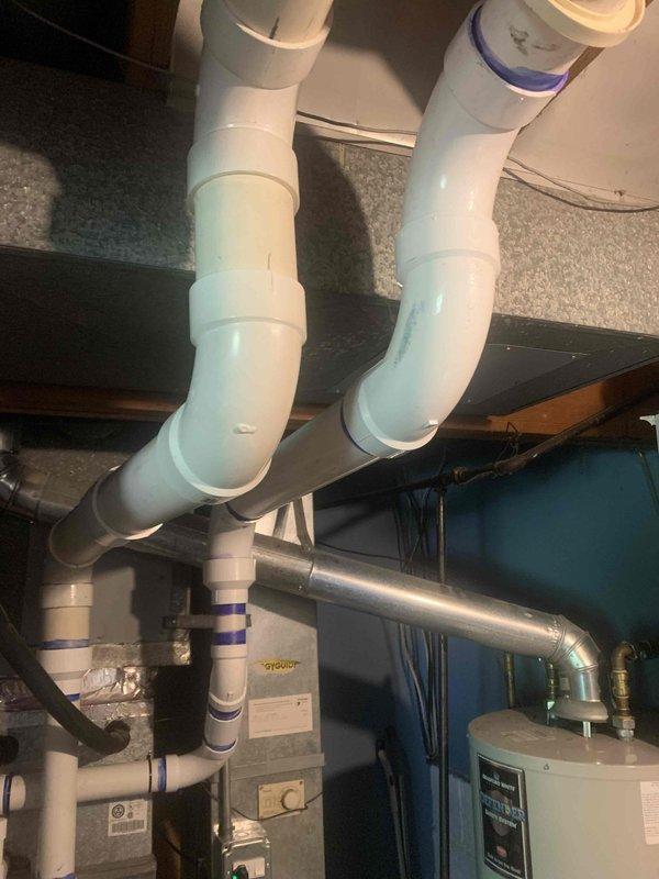 Completed callback for furnace installation to address code violation on exhaust venting system. Replaced cell core exhaust components with proper 3" PVC piping, ensuring all exhaust and intake venting meets current code requirements for the 70,000 BTU furnace unit. Verified proper termination of exterior vent pipes, secured all connections, and confirmed system operation and safe venting of combustion gases.