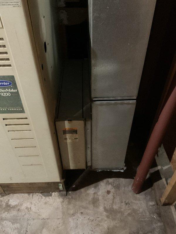 Provided replacement estimate for non-operational air conditioning system and existing Carrier WeatherMaker 9200 furnace located in basement utility area. Assessed current HVAC equipment configuration, electrical service capacity at exterior meter panel, outdoor condensing unit placement, and ductwork connections to determine appropriate replacement options and installation requirements.