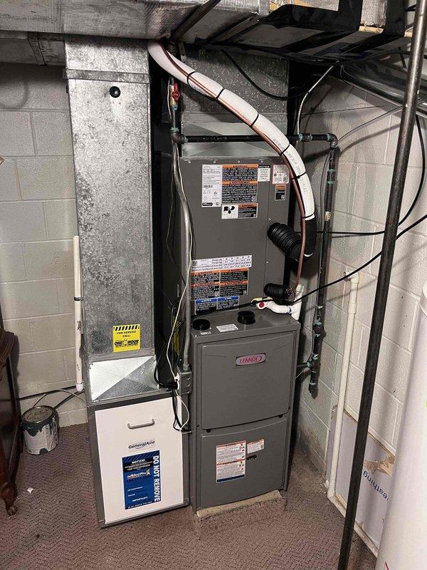 Completed full HVAC system installation including a 70,000 BTU Lennox furnace, 2.5-ton air conditioning unit with evaporator coil, and humidifier in basement location with rear discharge configuration. Performed all mechanical and electrical connections, installed copper refrigerant lines, ran condensate drainage, and completed ductwork connections to new equipment. Reconnected existing ductwork to new furnace plenum, mounted humidifier to supply plenum, and verified proper airflow through system. Commissioned air conditioning system using manifold gauges to verify refrigerant charge and system pressures, ensuring optimal performance of outdoor condensing unit. Tested furnace operation through full heating cycle, confirmed all safety controls and limit switches functioning properly, and verified humidifier water supply connection. Completed final system startup, programmed thermostat, and confirmed both heating and cooling modes operating within manufacturer specifications.