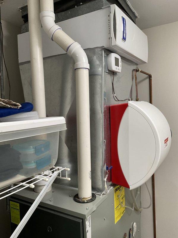 Conducted comprehensive evaluation of existing HVAC system for replacement estimate. Assessed indoor air handler unit with associated ductwork, humidifier accessory, and electrical components in mechanical room, as well as outdoor condenser unit with protective screening. Documented current equipment configuration, installation conditions, and photographed all components to provide accurate replacement specifications and pricing proposal.