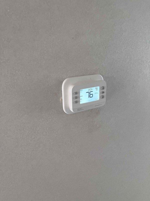 Completed replacement of manufactured home furnace with new 70,000 BTU unit. Installation included all mechanical and electrical connections, gas line hookup with flexible yellow corrugated connector, and thermostat programming. New furnace features control board, blower motor assembly, gas valve, and all safety components properly installed and tested. Unit commissioned and verified operational with thermostat set to 75°F.