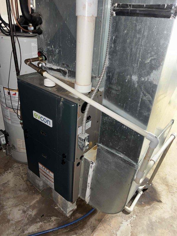 Conducted comprehensive evaluation of existing HVAC system including Evcon furnace and air handler unit for equipment replacement estimate. Assessed current system configuration, ductwork connections, condensate drainage lines, and overall installation condition to provide both single component air conditioning replacement option and complete system replacement quote. Documented equipment specifications, clearances, and existing infrastructure to prepare detailed proposal for customer consideration.