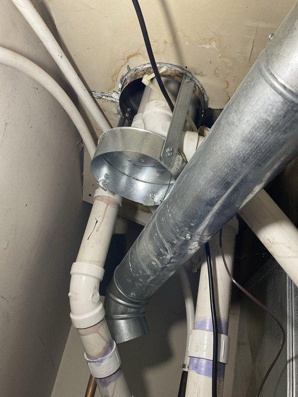 Provided estimate for water heater replacement in mechanical utility space. Documented existing Lochinvar water heating unit installation with associated PVC venting system, condensate drainage piping, and proximity to HVAC ductwork and air handler equipment for replacement planning and equipment sizing considerations.