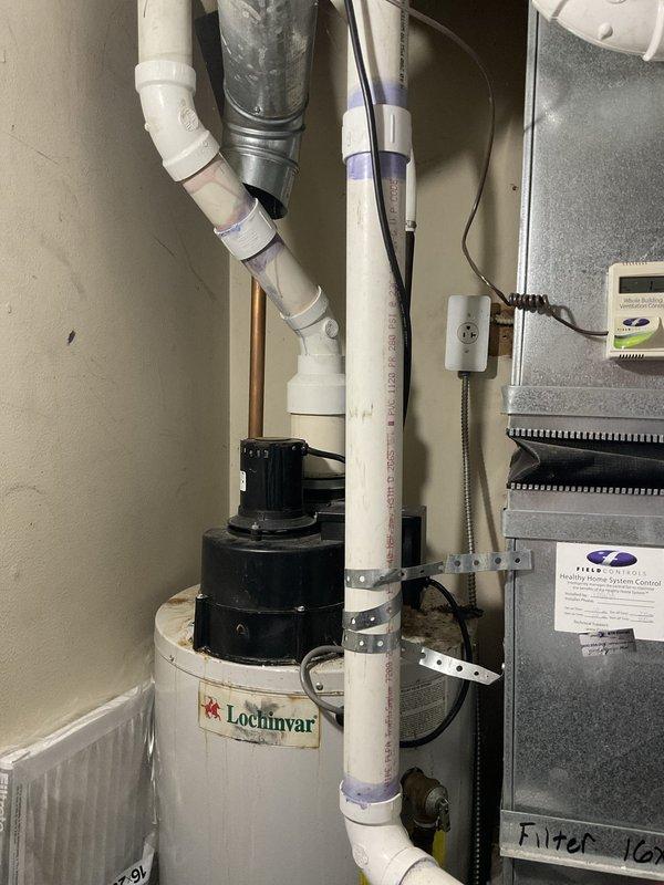 Provided estimate for water heater replacement in mechanical utility space. Documented existing Lochinvar water heating unit installation with associated PVC venting system, condensate drainage piping, and proximity to HVAC ductwork and air handler equipment for replacement planning and equipment sizing considerations.