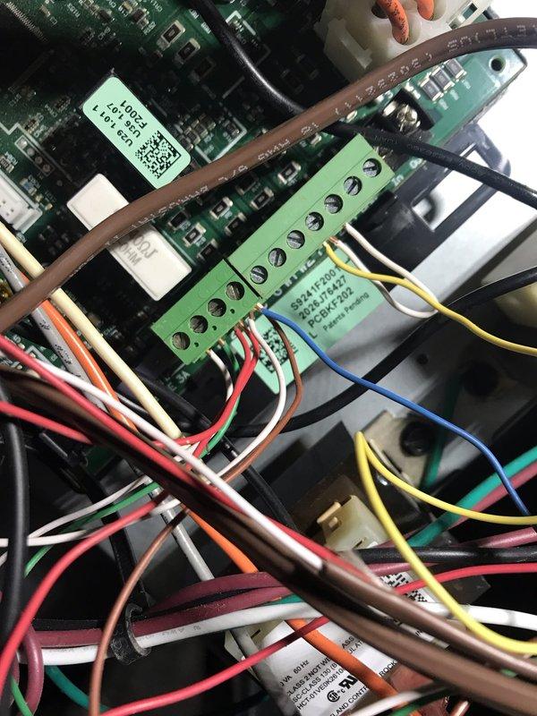 Responded to no cooling complaint on residential HVAC system. Upon arrival, inspected control board and wiring connections as customer suspected control board failure. Documented system information including A2L refrigerant safety classification label and control board terminal connections. Verified multiple wire terminations at control board including power, thermostat, and component connections. All wiring appeared properly secured to terminal block with appropriate color coding for circuit identification.