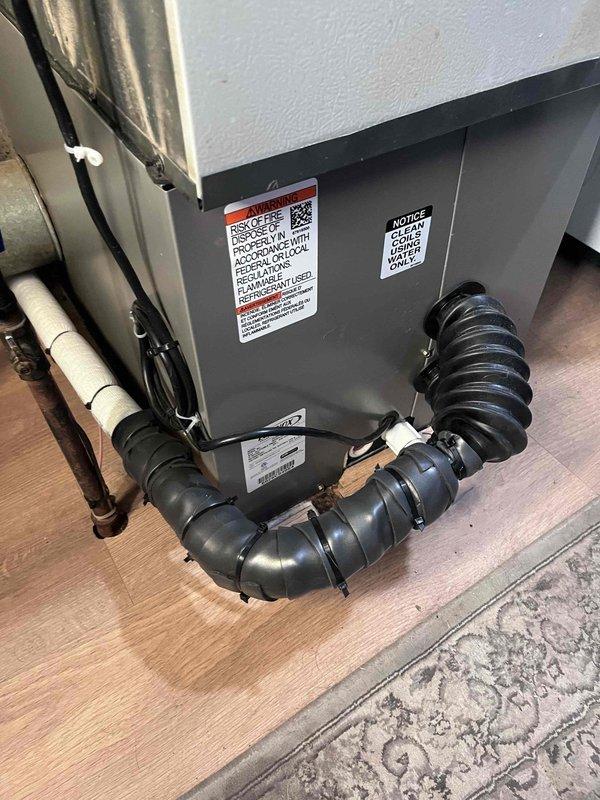 Responded to callback for reported coil leak on HVAC system. Upon inspection, located leak at evaporator coil connection point. Sealed leak area and reinstalled foam tape insulation on lineset. Secured all insulation with black zip ties to prevent future displacement. Documented installation with photos of indoor air handler unit and outdoor condenser connections. System tested and operating properly with no further refrigerant leaks detected.