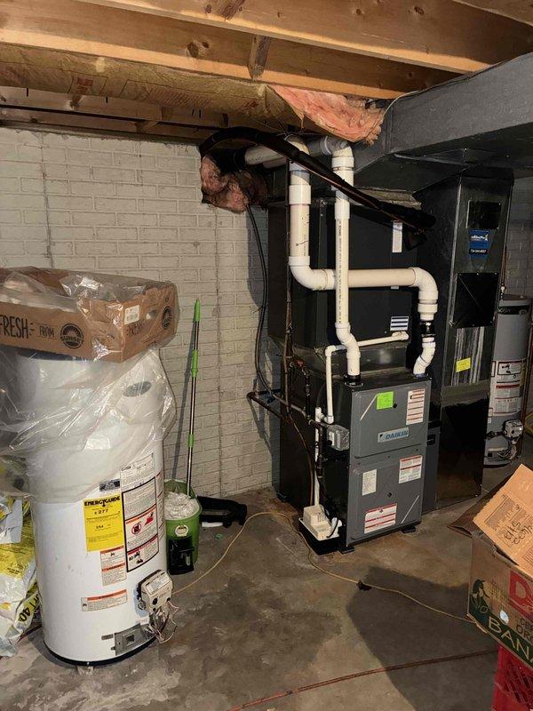 Completed estimate for whole-home dehumidifier installation to existing furnace system in basement mechanical room. Assessed current HVAC equipment configuration including black furnace unit with PVC venting and evaluated available space and electrical requirements for dehumidifier integration. Documented existing conditions and equipment layout to provide recommendations for IAQ improvement through humidity control.