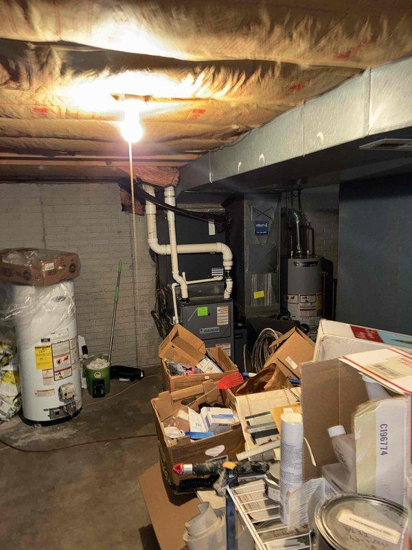 Completed estimate for whole-home dehumidifier installation to existing furnace system in basement mechanical room. Assessed current HVAC equipment configuration including black furnace unit with PVC venting and evaluated available space and electrical requirements for dehumidifier integration. Documented existing conditions and equipment layout to provide recommendations for IAQ improvement through humidity control.
