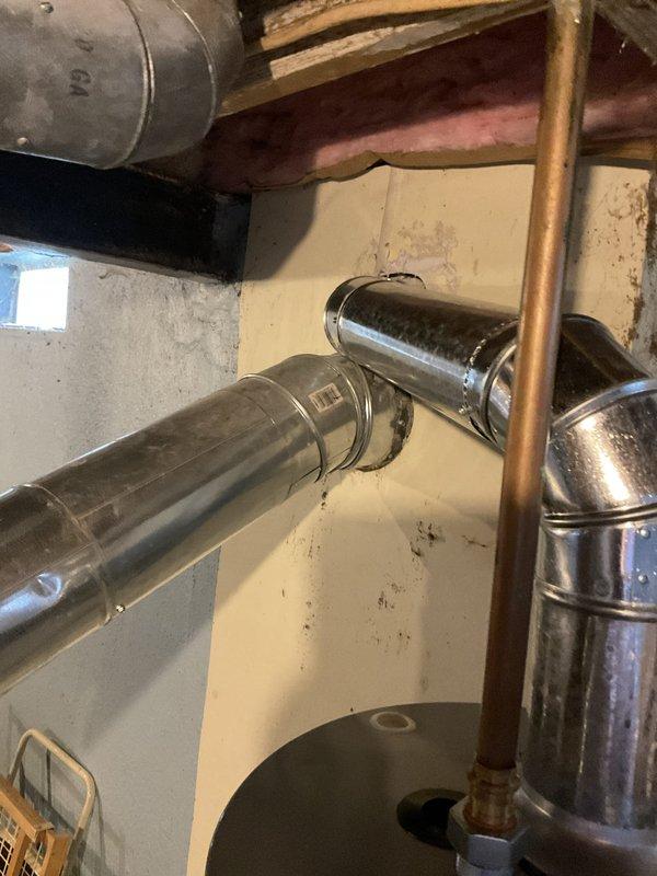 Performed estimate for furnace and air conditioning system replacement. Discovered AC disconnect box welded shut with melted wiring, rendering the unit unsafe for continued operation and not economically viable for repair. Documented existing HVAC infrastructure including ductwork, furnace installation, and water heater configuration for replacement planning purposes.