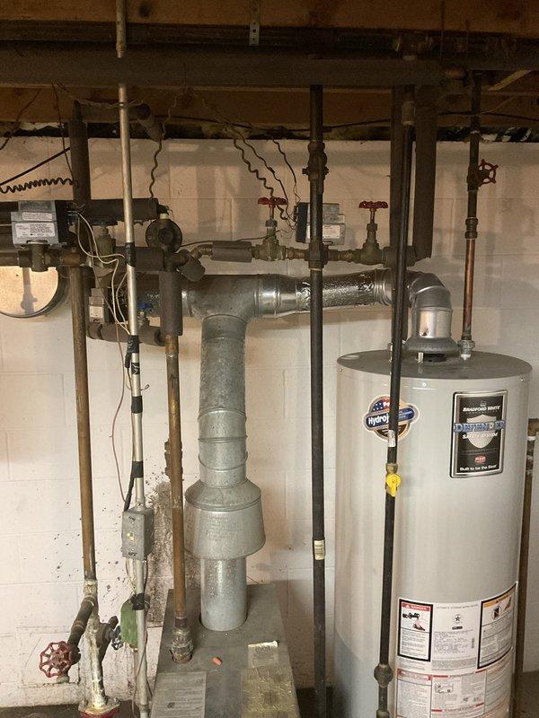 Conducted on-site evaluation of existing basement heating system for potential boiler replacement. Assessed current water heater and aging galvanized piping infrastructure, documenting equipment condition and configuration to provide estimate for combination boiler installation that would integrate both space heating and domestic hot water functions.