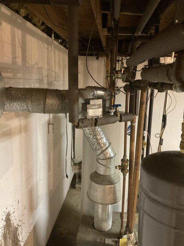 Conducted on-site evaluation of existing basement heating system for potential boiler replacement. Assessed current water heater and aging galvanized piping infrastructure, documenting equipment condition and configuration to provide estimate for combination boiler installation that would integrate both space heating and domestic hot water functions.