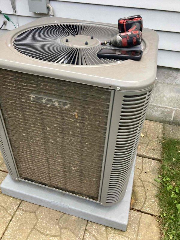 Completed scheduled preventative maintenance agreement visit on residential air conditioning system. Performed comprehensive inspection of outdoor condensing unit, noting accumulated dirt and debris on coil surfaces and louvers requiring attention. Cleaned condenser coils to restore optimal heat transfer efficiency and airflow. Verified proper operation of fan motor and compressor. Inspected electrical disconnect, conduit connections, and unit mounting on concrete pad. All components found operational following cleaning and inspection. System returned to normal service with improved cooling efficiency.