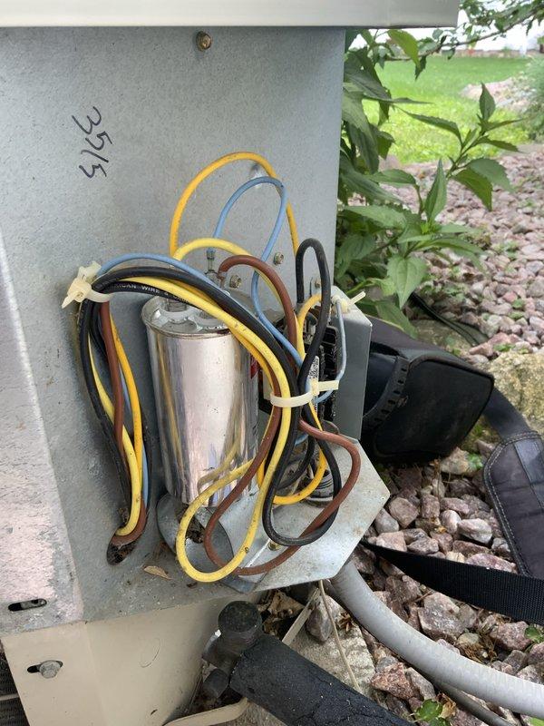 # AC Not Working 2-689

Responded to no cooling call on aging air conditioning system. Upon arrival, performed diagnostic evaluation of outdoor condensing unit and indoor air handler components. Inspection revealed failed dual run capacitor (35/5 MFD) on outdoor unit, which was preventing compressor and condenser fan motor from operating properly. Capacitor showed visible signs of deterioration and tested outside acceptable microfarad range.

Replaced defective dual run capacitor with new OEM-equivalent component rated at 35/5 MFD. Verified all electrical connections at outdoor disconnect and contactor were secure and properly torqued. Inspected indoor air handler electrical components, control board, and transformer for any secondary issues. All indoor components tested within normal operating parameters.

Restored power to system and monitored startup sequence. Compressor and outdoor fan motor engaged properly. Verified system achieved appropriate temperature split across evaporator 
