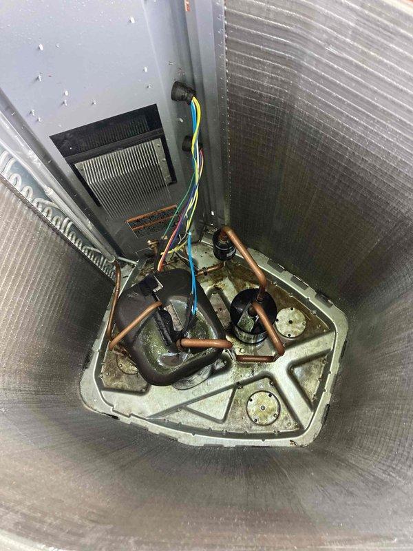 Completed preventative maintenance agreement visit on Club AC4-6 unit. Performed comprehensive inspection of indoor air handler system, documenting significant corrosion and deterioration of the drain pan with heavy staining and accumulated debris throughout the base. Inspected refrigerant lines, electrical connections, and condensate drain components. Verified electrical system operation using digital multimeter, recording voltage readings at 5.02V during testing. All copper refrigerant lines and connections were examined and found to be intact with normal patina consistent with unit age. Documented unit condition with photos showing advanced wear on drain pan requiring future attention. System operational at time of departure.