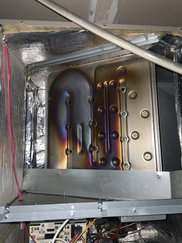Completed routine maintenance tune-up on 10-year-old furnace and air conditioning system. Inspected heat exchanger and noted heat stress discoloration patterns on metal surfaces, indicating normal operational wear consistent with system age. Checked blower assembly, intake grille, and ventilation components; cleaned accumulated dust and debris from air handler unit to ensure proper airflow and system efficiency.