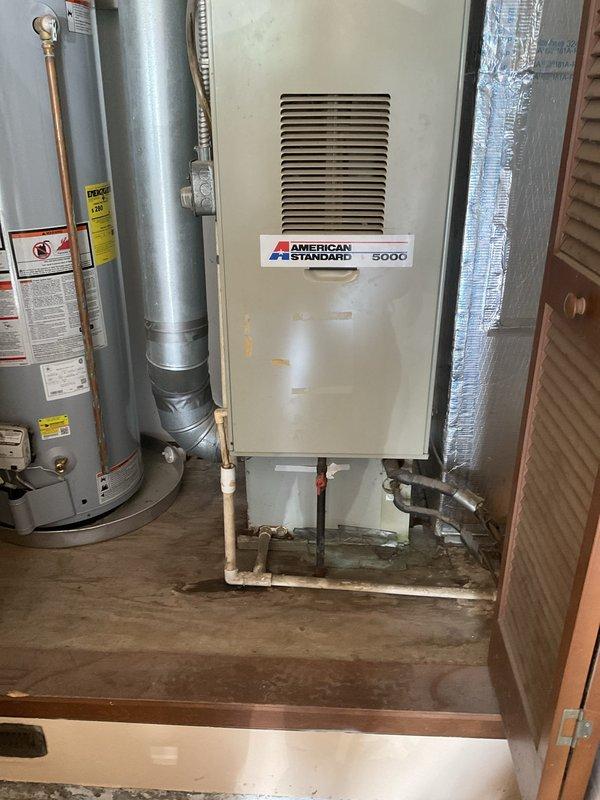Conducted comprehensive evaluation of 35-year-old HVAC system following non-operational air conditioning complaint and prior replacement recommendation from another contractor. Inspected existing American Standard Model 5000 furnace located in basement mechanical room and outdoor air conditioning unit to assess overall system condition, efficiency, and remaining service life. Documented current equipment configuration including ductwork connections, refrigerant lines, electrical components, and ventilation systems. Photographed furnace installation, surrounding mechanical components, and utility room layout to support replacement proposal. Provided detailed estimate for complete HVAC system replacement including new furnace and air conditioner to address aging equipment concerns and restore reliable climate control functionality.