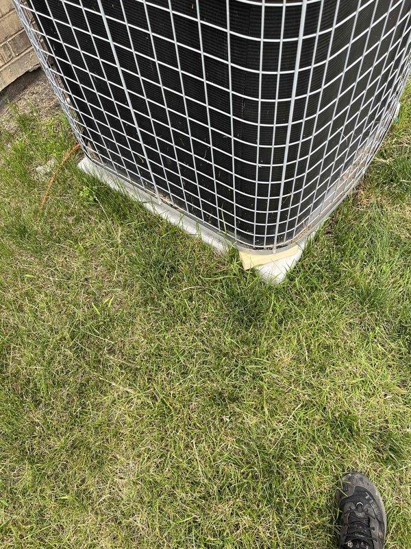 Completed comprehensive air conditioning tune-up on outdoor condensing unit. Performed standard maintenance inspection, verified proper operation of fan motor and compressor, cleaned debris from exterior surfaces, and documented equipment condition with service photos showing unit positioned on grass pad with adequate clearance for airflow.