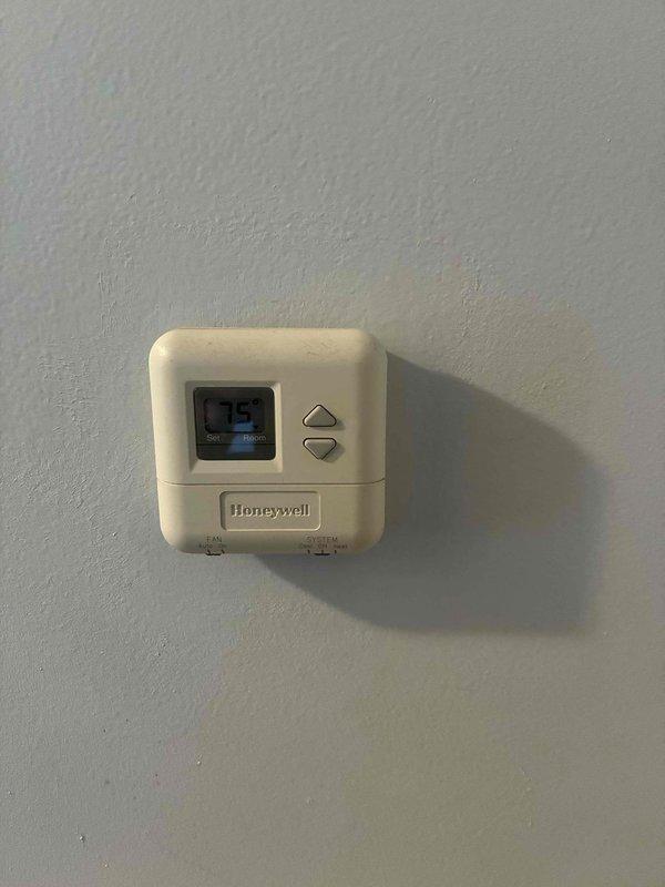 Conducted comprehensive HVAC system evaluation for replacement estimate. Documented existing Honeywell thermostat and exterior equipment location, photographed current system configuration including electrical meter and outdoor unit positioning. Provided detailed system replacement quote with equipment specifications and installation requirements.