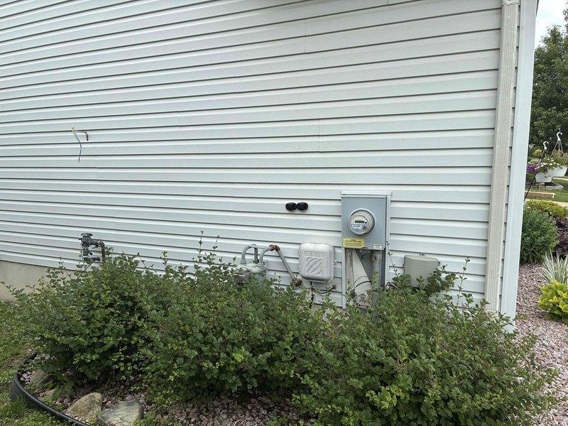 Conducted comprehensive HVAC system evaluation for replacement estimate. Documented existing Honeywell thermostat and exterior equipment location, photographed current system configuration including electrical meter and outdoor unit positioning. Provided detailed system replacement quote with equipment specifications and installation requirements.