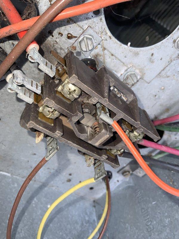 # HVAC Service Completion Report

Responded to no cooling complaint on 10+ year old air conditioning system. Upon arrival, performed diagnostic evaluation of outdoor condensing unit and associated electrical components. 

Inspection revealed failed contactor assembly preventing compressor and condenser fan operation. Contactor showed significant aging, corrosion on terminal connections, and carbon buildup on contact points consistent with extended service life. Electrical connections at contactor displayed discoloration and oxidation. Disconnect box examination showed aged wiring with weathered insulation throughout electrical pathway.

Replaced defective contactor with new OEM-equivalent component rated for system specifications. Cleaned and tightened all electrical terminations at contactor mounting location and disconnect box. Verified proper voltage supply at disconnect. Energized system and confirmed compressor and condenser fan motor startup. Monitored unit through complete cooli