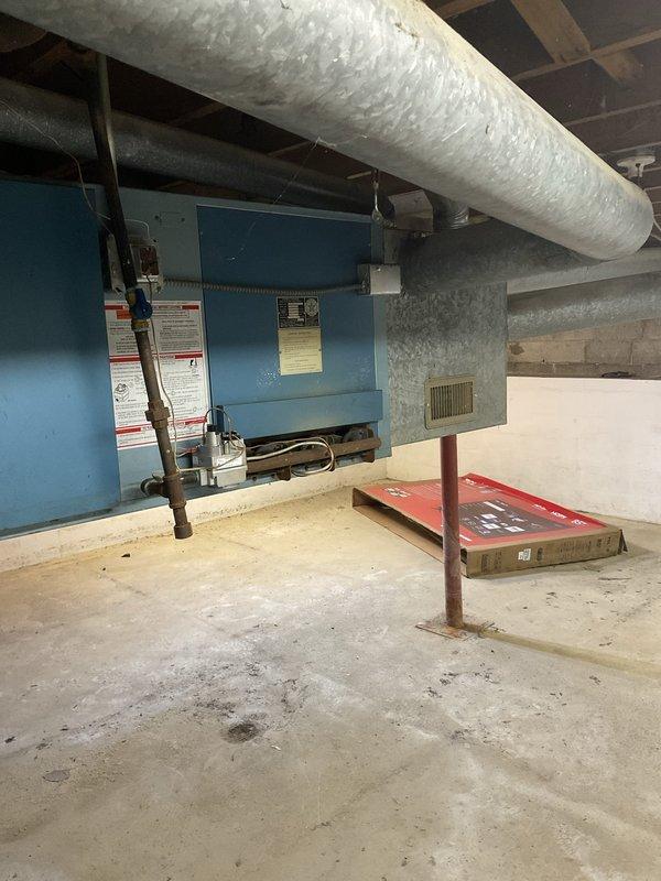 Conducted site evaluation of existing Armstrong air conditioning system located in Michigan basement to provide replacement estimate. Current unit is older model but operational at time of inspection. Assessed existing air handler configuration, ductwork connections, drainage system with PVC piping, and electrical supply routing. Documented equipment placement constraints in unfinished basement area with exposed joists, concrete flooring, and support columns. Evaluated clearance requirements and access considerations for future replacement installation. Provided comprehensive estimate for new AC system replacement compatible with natural gas furnace and existing duct infrastructure.