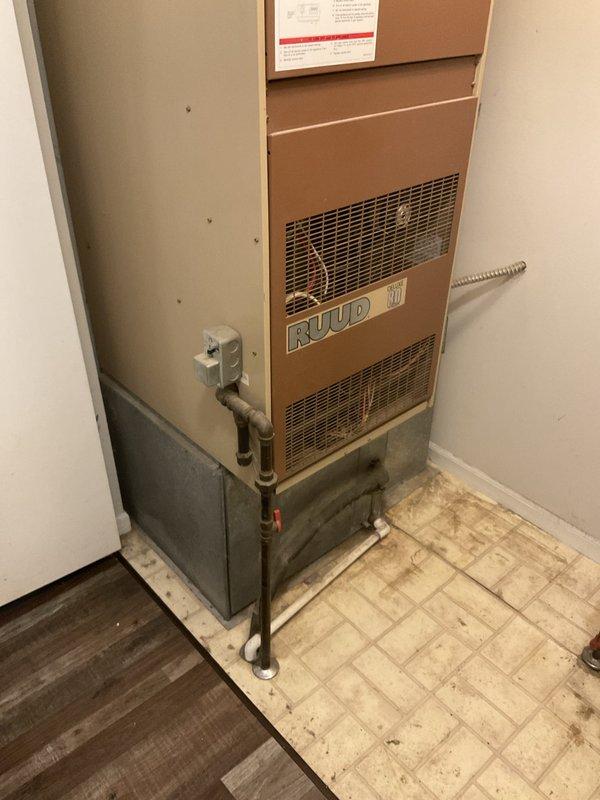 Conducted comprehensive assessment of existing Ruud natural gas furnace located in utility closet for replacement estimate. Unit confirmed operational but identified as very old system requiring replacement evaluation. Documented current installation configuration including ductwork connections, gas line routing, condensate piping, and equipment placement within confined mechanical room space for accurate replacement system sizing and specifications.