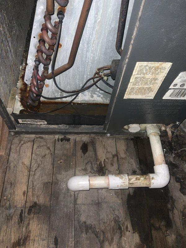 Completed preventative maintenance agreement visit for Club AC10-2 service on residential air conditioning and system inspection. Upon inspection, discovered significant frost and ice accumulation on refrigerant lines in attic space, indicating potential low refrigerant charge or restricted airflow issues requiring further diagnostic evaluation. Documented exterior condensing unit condition showing advanced corrosion on copper refrigerant piping and deteriorated wooden equipment platform requiring attention to prevent future equipment damage and ensure proper system operation.