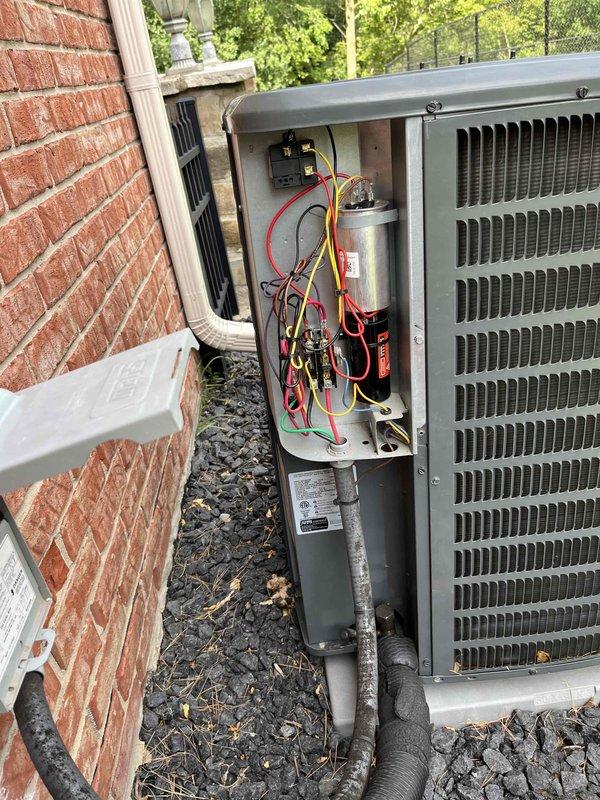 Completed installation of condenser fan motor and hard start kit on residential air conditioning unit. Accessed electrical compartment, removed failed motor, installed replacement motor with proper wiring connections to capacitor and contactor. Added hard start kit to assist compressor during startup cycles. Verified all electrical connections were secure, tested unit operation, and confirmed proper cooling function before closing service panel.