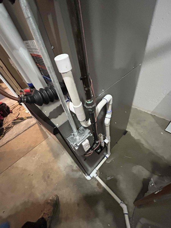 Completed full HVAC system installation at residential property. Installed new furnace and air conditioning equipment in basement utility area with proper ductwork integration, condensate pump assembly, and PVC drainage piping. All components tested and operational, financing paperwork finalized, and job site documentation photographed upon completion.