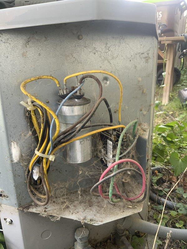 Responded to no heat call where homeowner reported fan not operating and reduced heating capacity. Upon inspection, found outdoor condensing unit with failed dual run capacitor showing visible deterioration and corrosion from extended outdoor exposure. Replaced defective capacitor, cleaned electrical connections, removed debris and spider webs from enclosure, tested system operation, and verified proper fan motor function and heating restoration.