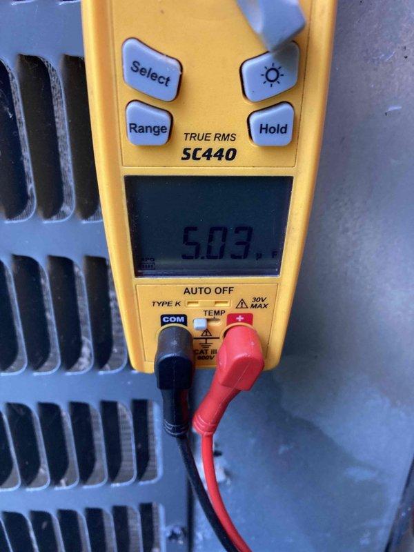Responded to no cooling complaint on unit under 10 years old. Upon arrival, performed diagnostic testing using digital multimeter to measure electrical parameters and inspected condenser fan motor assembly. Found condenser fan motor operational with proper voltage readings of approximately 5V at temperature sensor connection, and fan blades rotating freely without obstruction or mechanical binding.