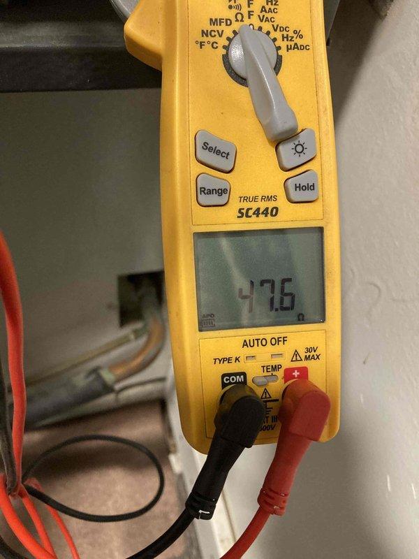 # No Cool Service Call - 12-Year-Old AC System

Responded to service call for reduced cooling capacity on 12-year-old air conditioning system. Customer reported unit was struggling to maintain temperature during peak heat conditions, though system remained operational.

Upon arrival, performed visual inspection of outdoor condensing unit located in backyard. Discovered heavily corroded fuse block with significant copper terminal oxidation and green patina formation indicating prolonged moisture exposure and age-related deterioration. Removed fuse block assembly for detailed examination, confirming advanced corrosion on both copper terminals and compromised electrical connections.

Conducted electrical diagnostics using digital multimeter to verify system performance parameters. Measured capacitor microfarad rating at 47.6 µF to assess component condition and determine if capacitor degradation was contributing to reduced cooling efficiency.

The combination of corroded electrical connec