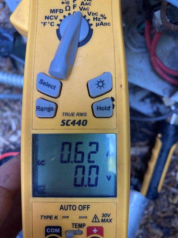 Responded to no cooling complaint on aging air conditioning system. Upon arrival, performed electrical diagnostics using digital multimeter to test capacitor and voltage readings. Measurements indicated capacitor failure with reading of 50.1 MFD and low voltage of 0.624V, preventing compressor from operating properly. Replaced failed dual run capacitor to restore proper system operation and verified all electrical connections were secure and within manufacturer specifications.