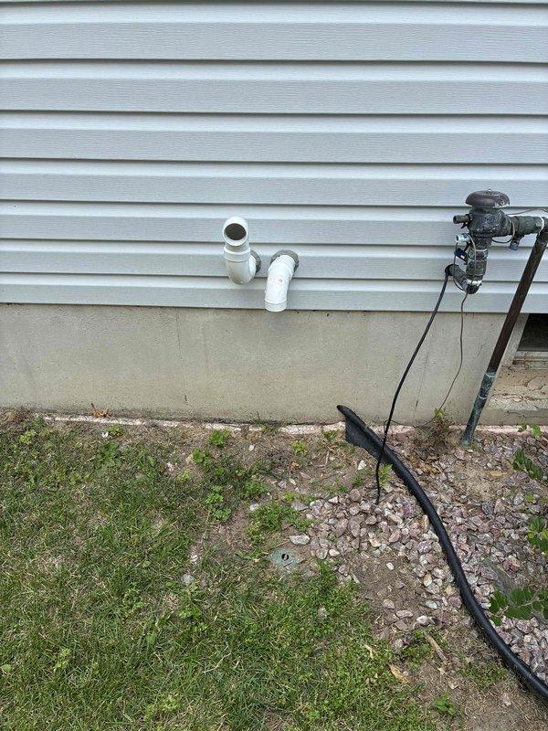 Completed full HVAC system installation including a 70,000 BTU furnace and 3-ton air conditioning unit in the rear yard location. Performed all mechanical and electrical connections, installed condensate drainage piping with proper termination at exterior wall, and reconnected all necessary utilities. Verified system operation with pressure testing showing 424 PSI readings, confirming proper refrigerant charge and system functionality.